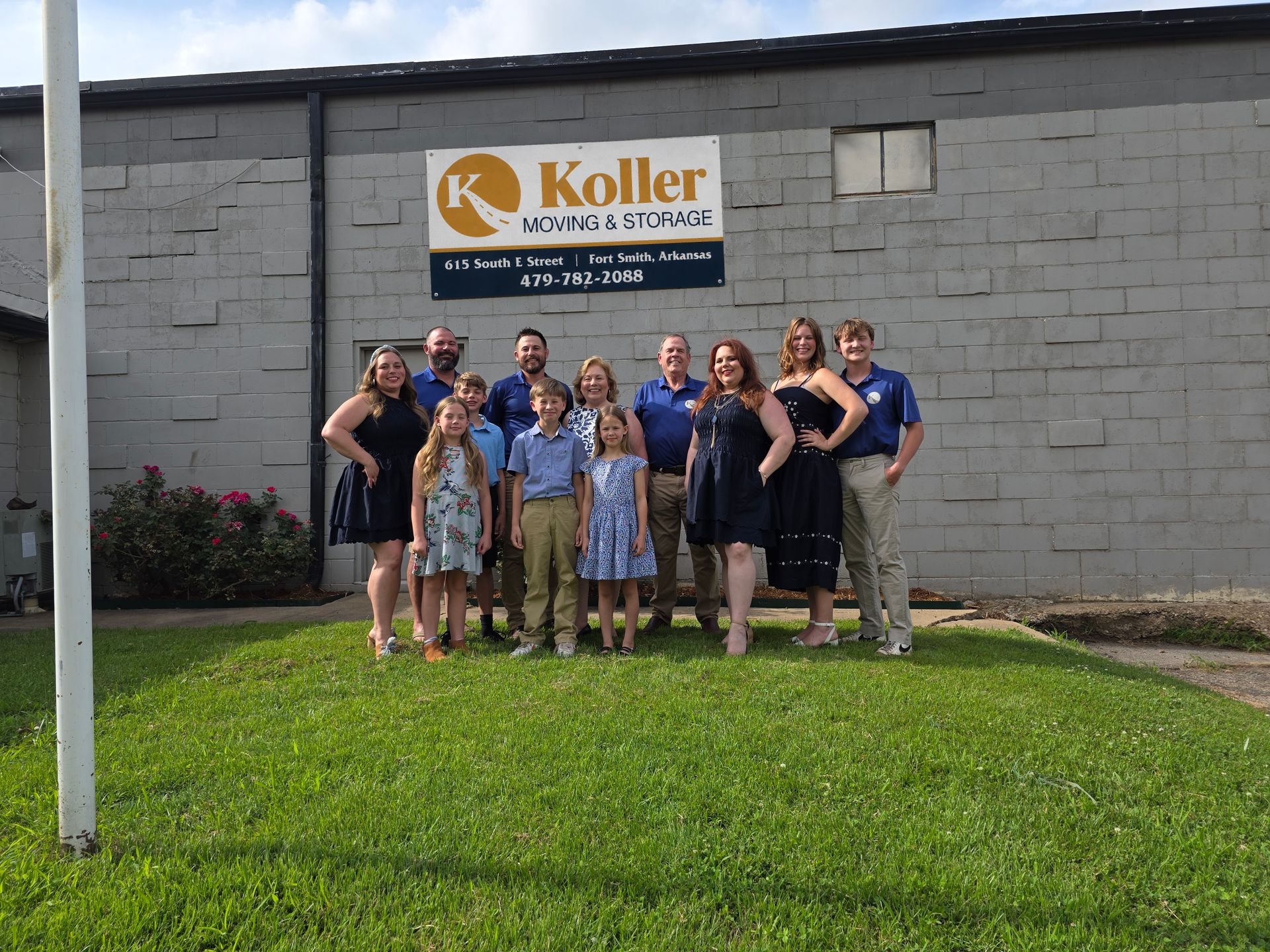 The Koller family in front of the Koller Moving & Storage sign in Fort Smith, AR